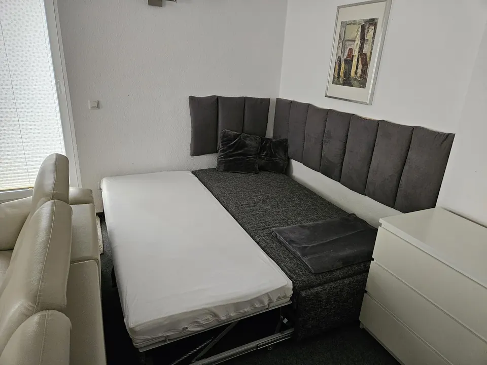 Ausgeklapptes Schlafsofa im Wohnbereich als zusätzliche Schlafmöglichkeit